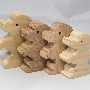 Handmade wood poodle puppy cutout made from unfinished wood. It is sanded and ready to paint. It is freestanding and an excellent pretend toy that can also be used for crafts.