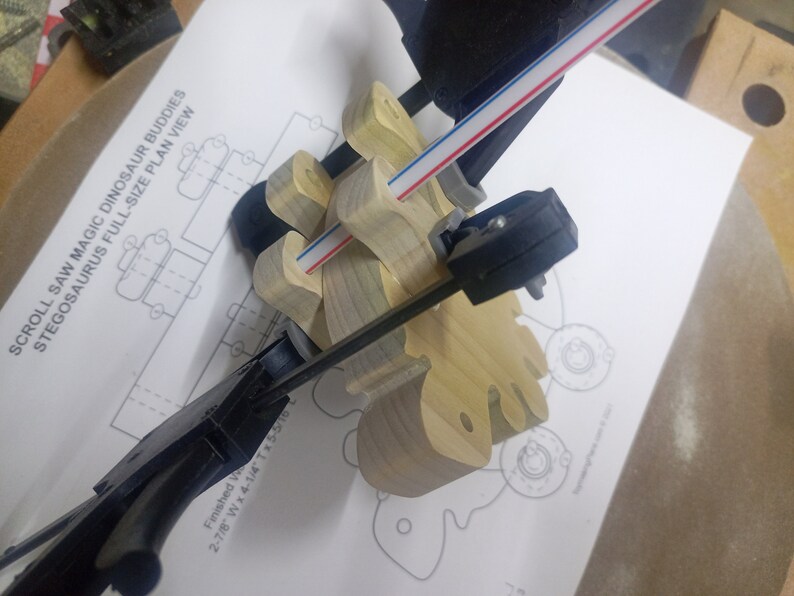 Handmade push toy stegosaurus crafted from select grade hardwoods in my toymakers shop. Legs are being glued on.