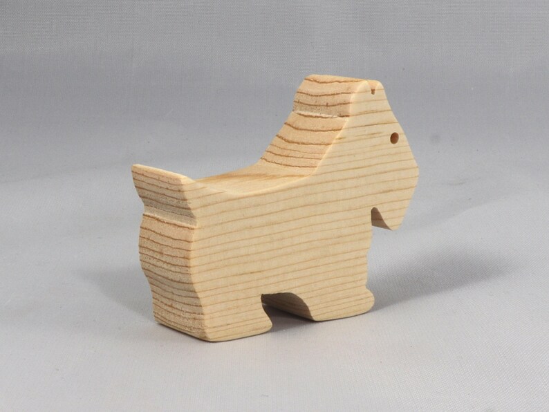 Handmade wood toy Scottie dog cutout unfinished unpainted paintable freestanding Itty Bitty Animal Collection. Approximate size 2.5 inches length by 2 inches height by 0.75 inches width. Handmade in Tallahassee Florida USA from natural wood offcuts.