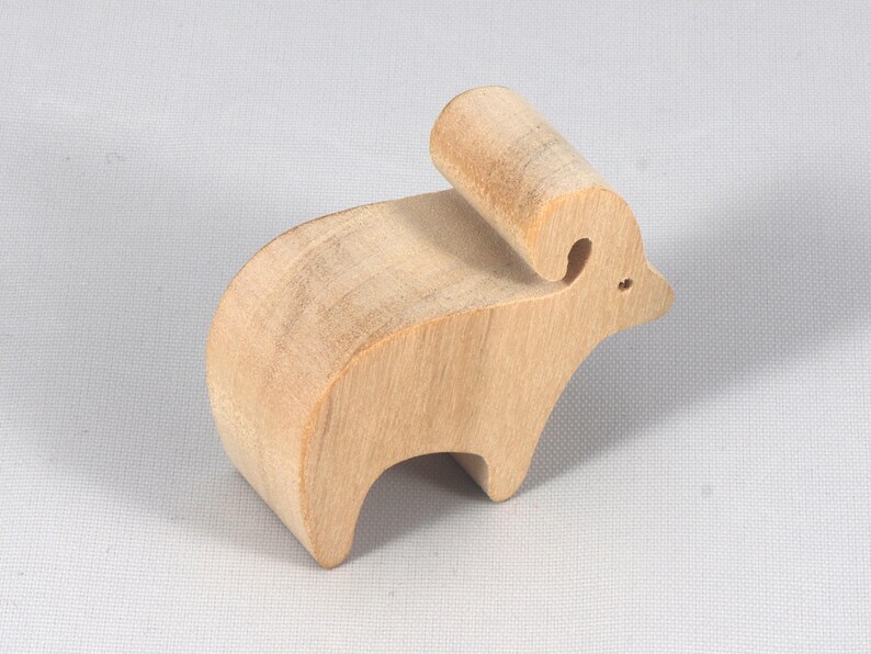 This is an unfinished wooden Ram cutout from solid wood using traditional woodworking techniques. Sanded smooth and ready to paint, stain, or customize. Freestanding design for small hands, toddlers, young children, crafters, collectors, and display. I take custom orders for any animal, quantity, and mix — including large ornament orders. Mix and match, request a different size, or send a drawing or pattern. Handmade by Odin's Toy Factory in Tallahassee, Florida, USA.