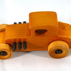 Handmade Wood Toy Car Hot Rod Based On The 1927 T-Coupe. It Has Been Hand-Finished With Multiple Coats Of Amber Shellac And Trimmed With Black Acrylic Paint.