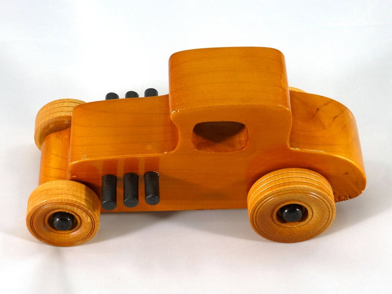 Handmade Wood Toy Car Hot Rod Based On The 1927 T-Coupe. It Has Been Hand-Finished With Multiple Coats Of Amber Shellac And Trimmed With Black Acrylic Paint.
