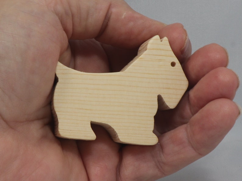 Handmade wood toy Scottie dog cutout unfinished unpainted paintable freestanding Itty Bitty Animal Collection. Approximate size 2.5 inches length by 2 inches height by 0.75 inches width. Handmade in Tallahassee Florida USA from natural wood offcuts.