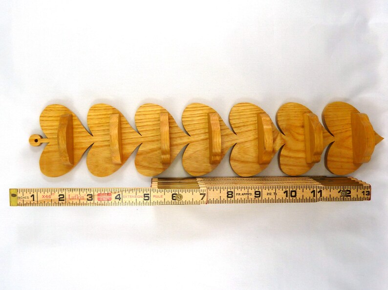 Handmade heart-shaped shelf crafted from reclaimed oak hardwood and finished with polyurethane. Perfect for displaying small items and adding rustic charm to home decor.