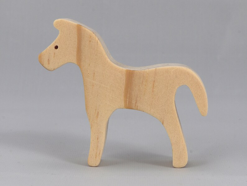 Handmade wooden toy horse cutout, perfect for children's playtime collection. Freestanding and stackable, ready to paint or customize. Endless possibilities for imaginative play, from farm scenes to towering animal creations.
