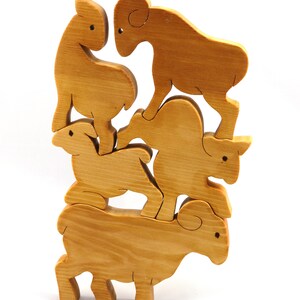 Handmade wooden toy stacking puzzle with five freestanding goats finished with a custom blend of nontoxic oils and waxes.