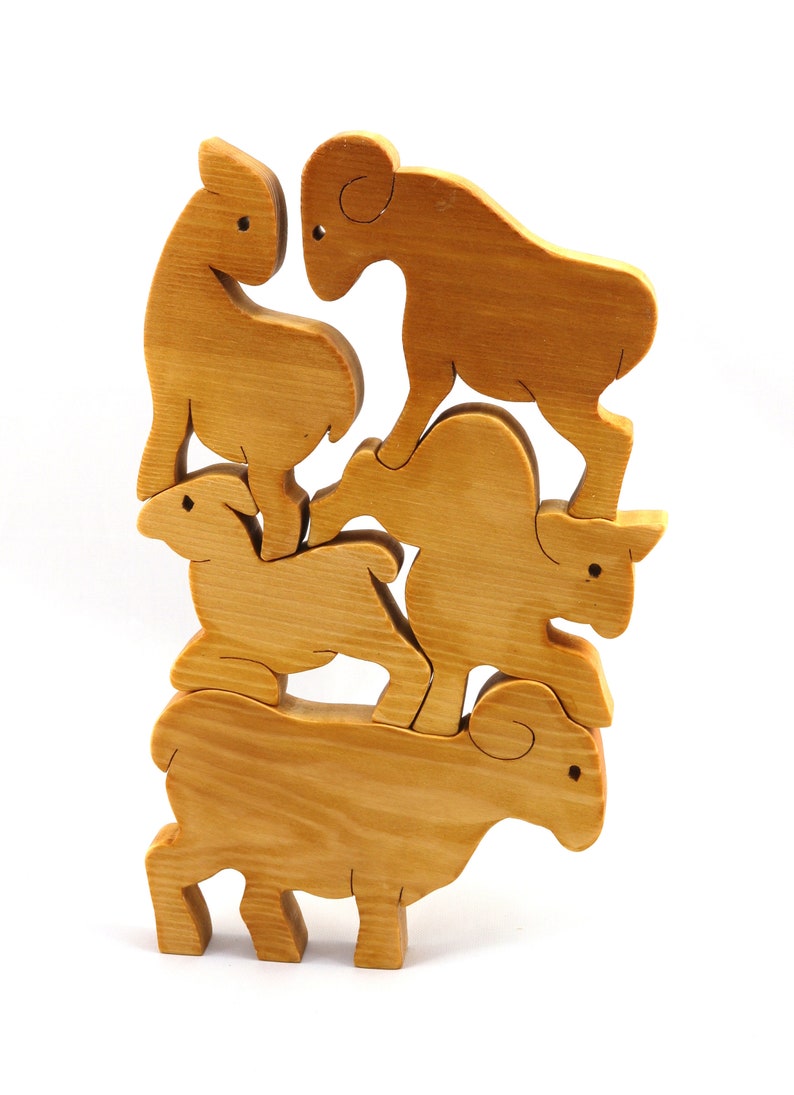 Handmade wooden toy stacking puzzle with five freestanding goats finished with a custom blend of nontoxic oils and waxes.