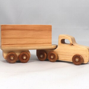 Handmade wooden toy tractor trailer semi truck finished with clear shellac. Crafted from natural wood using traditional woodworking tools. Approximate size 7 inches long. Made in Tallahassee, Florida, USA from Odin's Toy Factory Play Pal Collection.