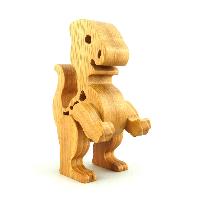 Handmade wooden baby dinosaur figurines, set of 3, made from hardwood with a natural oil and wax finish. Each baby dinosaur measures approximately 3 to 4 inches in height and length. Handmade in Tallahassee, Florida, USA at Odin's Toy Factory.