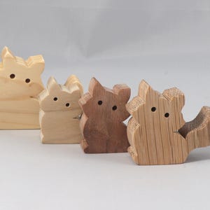 This is an unfinished wooden Fluffy Kitten cutout from solid wood using traditional woodworking techniques. Sanded smooth and ready to paint, stain, or customize. Freestanding design for small hands, toddlers, young children, crafters, collectors, and display. I take custom orders for any animal, quantity, and mix — including large ornament orders. Mix and match, request a different size, or send a drawing or pattern. Handmade by Odin's Toy Factory in Tallahassee, Florida, USA.