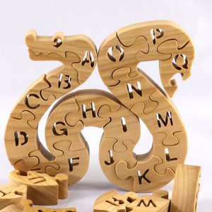 Hand-cut Alphabet Snake Puzzle made from premium hardwood, finished with mineral oil and beeswax for durability. Each of the 26 pieces represents a letter, promoting alphabet learning and essential skills development in kids through play.