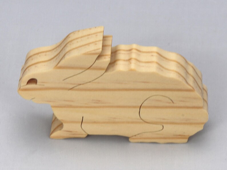 This is an unfinished wooden Rabbit cutout from solid wood using traditional woodworking techniques. Sanded smooth and ready to paint, stain, or customize. Freestanding design for small hands, toddlers, young children, crafters, collectors, and display. I take custom orders for any animal, quantity, and mix — including large ornament orders. Mix and match, request a different size, or send a drawing or pattern. Handmade by Odin's Toy Factory in Tallahassee, Florida, USA.