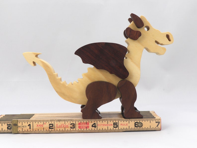 Wood Dragon Fantasy Animal Figurine is Handmade and finished with a renewable blend of mineral oil and waxes Applied hot for durabiliity and to enhance the beauty of the wood. There are ten dragons in this collection. A  link is in the description.