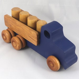 This handmade wooden Lorry truck is finished with navy blue acrylic paint and Amber Shellac. It is one of five towable trucks in this collection, available in many colors and unfinished. Custom Orders are welcome.