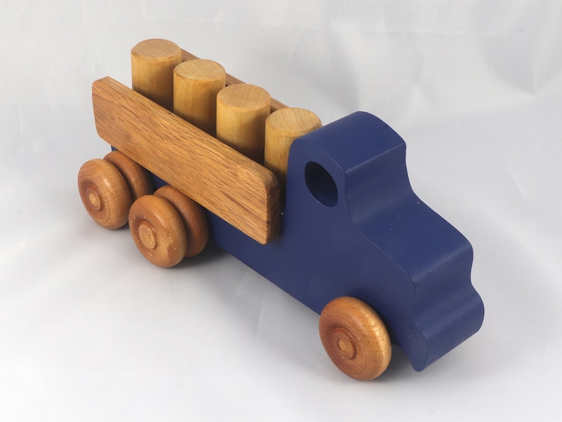 This handmade wooden Lorry truck is finished with navy blue acrylic paint and Amber Shellac. It is one of five towable trucks in this collection, available in many colors and unfinished. Custom Orders are welcome.
