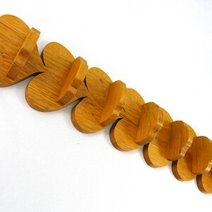 Handmade heart-shaped shelf crafted from reclaimed oak hardwood and finished with polyurethane. Perfect for displaying small items and adding rustic charm to home decor.