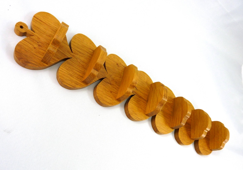 Handmade heart-shaped shelf crafted from reclaimed oak hardwood and finished with polyurethane. Perfect for displaying small items and adding rustic charm to home decor.