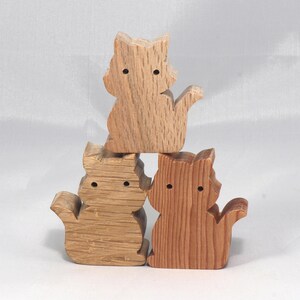 This is an unfinished wooden Cat cutout from solid wood using traditional woodworking techniques. Sanded smooth and ready to paint, stain, or customize. Freestanding design for small hands, toddlers, young children, crafters, collectors, and display. I take custom orders for any animal, quantity, and mix — including large ornament orders. Mix and match, request a different size, or send a drawing or pattern. Handmade by Odin's Toy Factory in Tallahassee, Florida, USA.