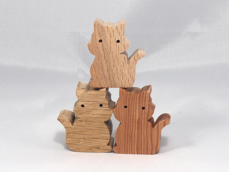 This is an unfinished wooden Cat cutout from solid wood using traditional woodworking techniques. Sanded smooth and ready to paint, stain, or customize. Freestanding design for small hands, toddlers, young children, crafters, collectors, and display. I take custom orders for any animal, quantity, and mix — including large ornament orders. Mix and match, request a different size, or send a drawing or pattern. Handmade by Odin's Toy Factory in Tallahassee, Florida, USA.