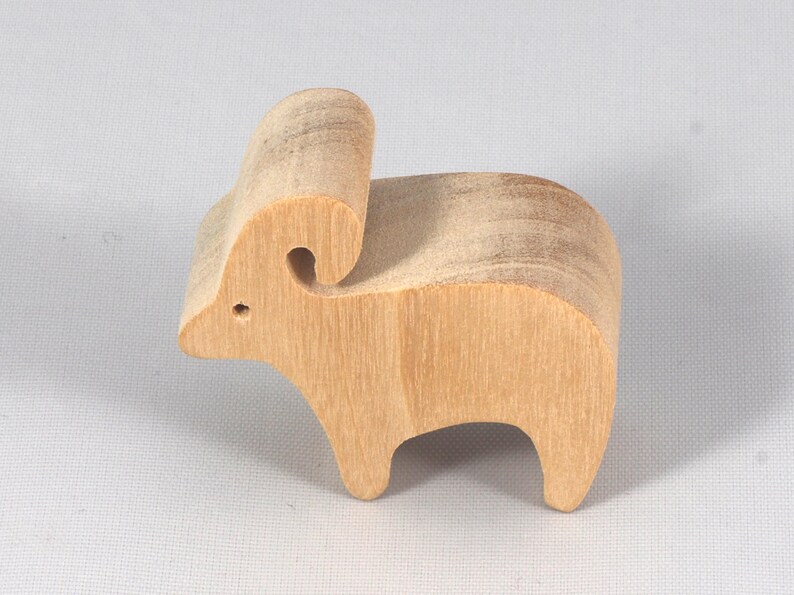This is an unfinished wooden Ram cutout from solid wood using traditional woodworking techniques. Sanded smooth and ready to paint, stain, or customize. Freestanding design for small hands, toddlers, young children, crafters, collectors, and display. I take custom orders for any animal, quantity, and mix — including large ornament orders. Mix and match, request a different size, or send a drawing or pattern. Handmade by Odin's Toy Factory in Tallahassee, Florida, USA.