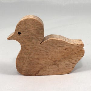 This is an unfinished wooden Duck cutout from solid wood using traditional woodworking techniques. Sanded smooth and ready to paint, stain, or customize. Freestanding design for small hands, toddlers, young children, crafters, collectors, and display. I take custom orders for any animal, quantity, and mix — including large ornament orders. Mix and match, request a different size, or send a drawing or pattern. Handmade by Odin's Toy Factory in Tallahassee, Florida, USA.
