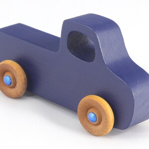 Handmade wooden toy pickup truck handmade and painted navy blue with amber shellac wheels and metallic sapphire blue trim. It's a little blue truck from my Play Pal Collection.