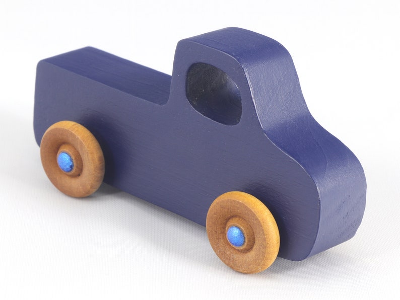 Handmade wooden toy pickup truck handmade and painted navy blue with amber shellac wheels and metallic sapphire blue trim. It's a little blue truck from my Play Pal Collection.