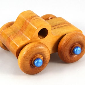 Wood Toy Monster Truck Handmade Form Hardwood and Finished With Amber Shellac With Metallic Saphire Blue Trim.