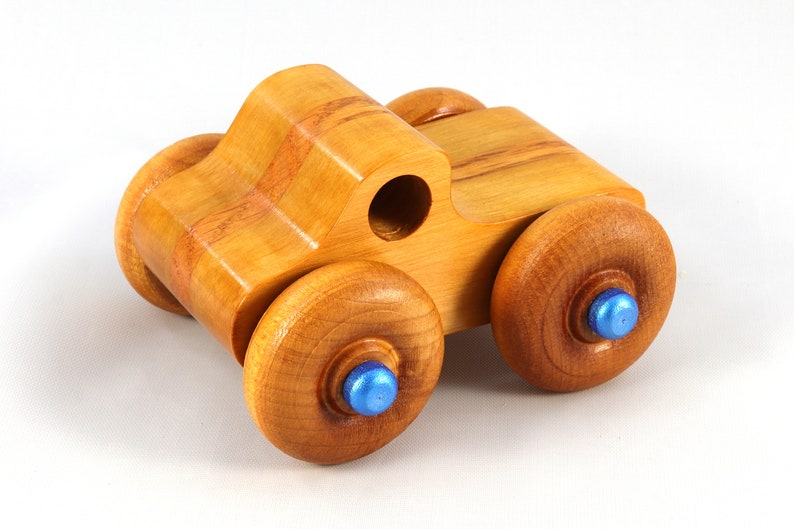 Wood Toy Monster Truck Handmade Form Hardwood and Finished With Amber Shellac With Metallic Saphire Blue Trim.