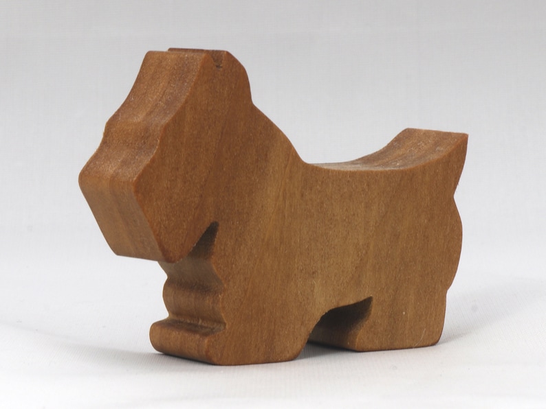 Handmade wooden Scottie dog toy cutout finished with mineral oil and beeswax blend. Freestanding stackable design from my Itty Bitty Animal Collection. Handcrafted in Tallahassee, Florida, USA from quality hardwood. Approximate size: length 2-1/2 inches, height 2 inches, width 3/4 inch. Each piece is unique with natural wood grain variations.
