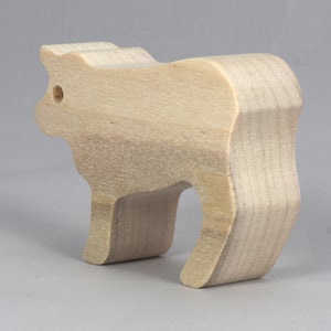 Handmade unfinished wooden toy baby calf cutout, unpainted and ready to paint, freestanding farm animal figure from Odin's Toy Factory’s  Itty Bitty Animal Collection. Handcrafted in Tallahassee, Florida, USA, using reclaimed natural wood offcuts. Perfect for imaginative play, stacking, collectors, and crafting.