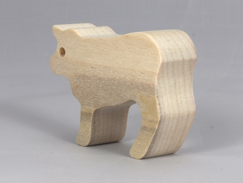 Handmade unfinished wooden toy baby calf cutout, unpainted and ready to paint, freestanding farm animal figure from Odin's Toy Factory’s  Itty Bitty Animal Collection. Handcrafted in Tallahassee, Florida, USA, using reclaimed natural wood offcuts. Perfect for imaginative play, stacking, collectors, and crafting.