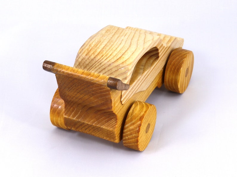 Handmade wooden toy car finished with nontoxic clear amber shellac and contrasting wood trim. Part of the Speedy Wheels Collection. Handcrafted in Tallahassee, Florida, USA. Length 5-1/2 inches, width 2-1/2 inches, height 2-1/2 inches. Made at Odin's Toy Factory.