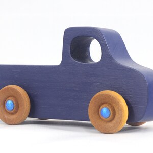 Handmade wooden toy pickup truck handmade and painted navy blue with amber shellac wheels and metallic sapphire blue trim. It's a little blue truck from my Play Pal Collection.