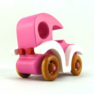 Handmade wooden toy car model-t sedan finished with hot pink and white acrylic paint with nonmaring amber shellac coated spoked wheels from my Bad Bob'S Custom Motors Collection.