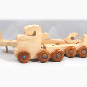 Handmade wooden toy truck play set includes three cars and a tractor-trailer finished with clear and amber shellac with metallic sapphire blue trim.