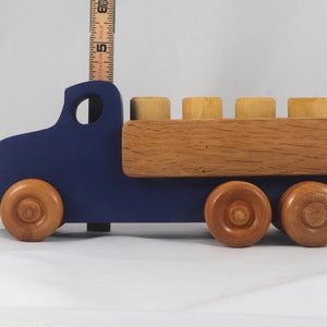 This handmade wooden Lorry truck is finished with navy blue acrylic paint and Amber Shellac. It is one of five towable trucks in this collection, available in many colors and unfinished. Custom Orders are welcome.
