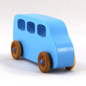 A Handmade wood toy mini van hand-painted baby blue with metallic sapphire blue trim and wheels finished with nonmarring amber shellac from my Play Pall Collection.