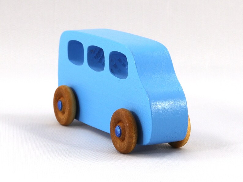 A Handmade wood toy mini van hand-painted baby blue with metallic sapphire blue trim and wheels finished with nonmarring amber shellac from my Play Pall Collection.