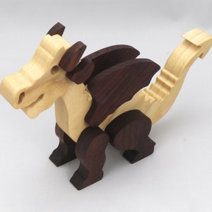 Wood Dragon Fantasy Animal Figurine is Handmade and finished with a renewable blend of mineral oil and waxes Applied hot for durabiliity and to enhance the beauty of the wood. There are ten dragons in this collection. A  link is in the description.