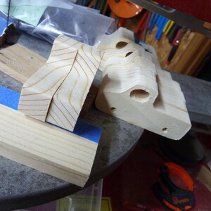 Wooden toy pickup truck bodies and cut wood pieces in my workshop, shown during construction before sanding and finishing.