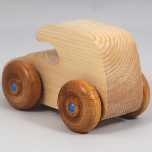 Handmade wooden toy car. The body is finished with clear shellac, and the wheels are finished with amber shellac. The hubs are painted with metallic sapphire blue trim.