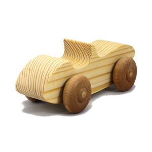 A small, handcrafted wooden toy convertible sports car, finished with a custom blend of oils and waxes, is the perfect gift for young children.