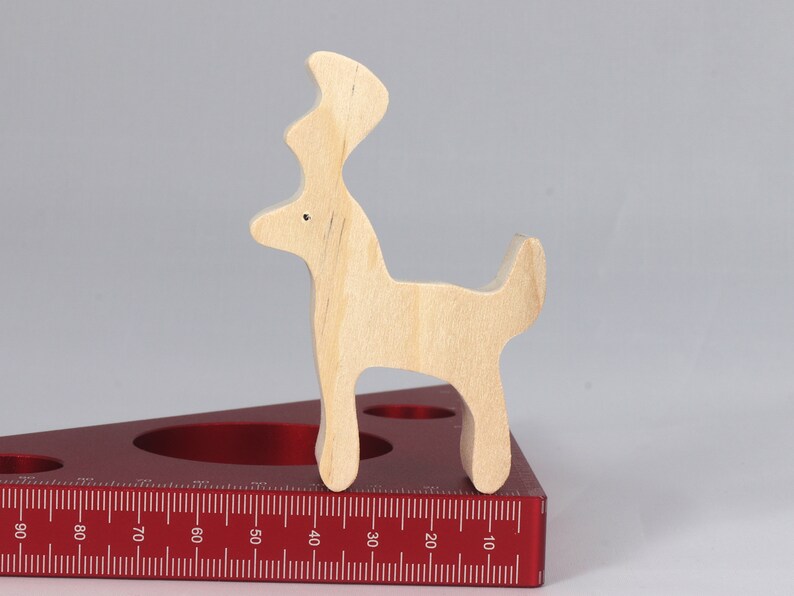 Handmade unfinished wooden deer toy figurine, part of the Itty Bitty Animal Collection, shown in natural light wood with visible grain, standing on a white background.