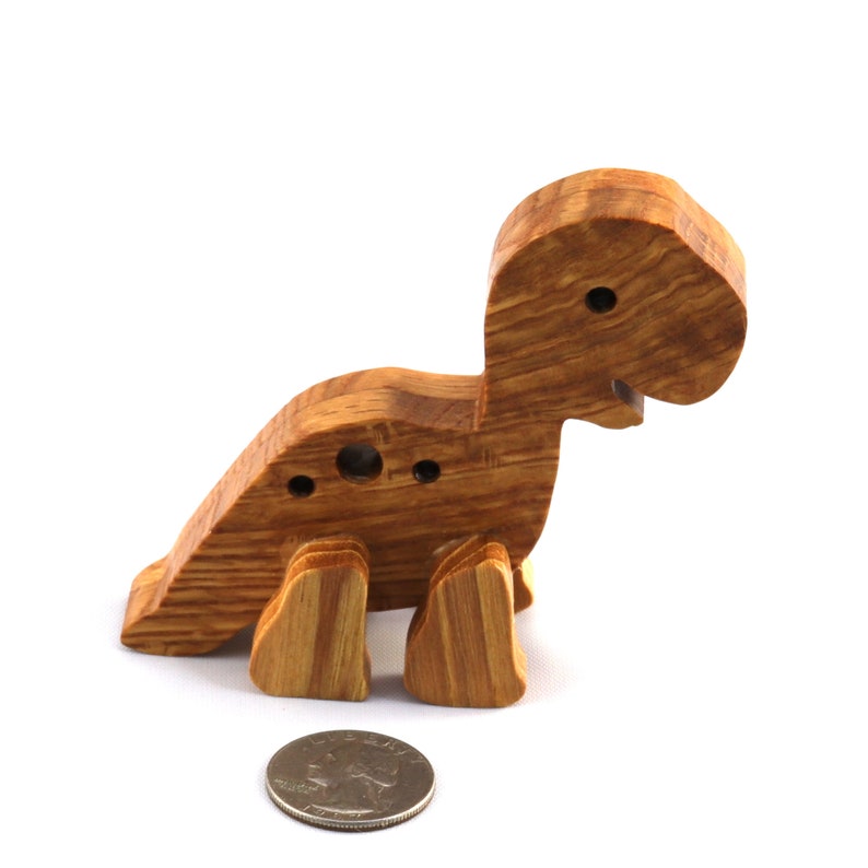 Handmade wooden baby dinosaur figurines, set of 3, made from hardwood with a natural oil and wax finish. Each baby dinosaur measures approximately 3 to 4 inches in height and length. Handmade in Tallahassee, Florida, USA at Odin's Toy Factory.