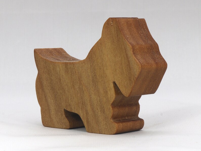 Handmade wooden Scottie dog toy cutout finished with mineral oil and beeswax blend. Freestanding stackable design from my Itty Bitty Animal Collection. Handcrafted in Tallahassee, Florida, USA from quality hardwood. Approximate size: length 2-1/2 inches, height 2 inches, width 3/4 inch. Each piece is unique with natural wood grain variations.