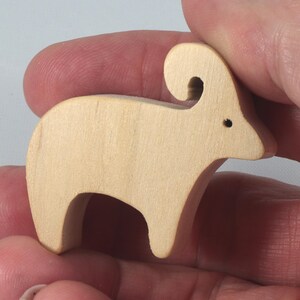 This is an unfinished wooden Ram cutout from solid wood using traditional woodworking techniques. Sanded smooth and ready to paint, stain, or customize. Freestanding design for small hands, toddlers, young children, crafters, collectors, and display. I take custom orders for any animal, quantity, and mix — including large ornament orders. Mix and match, request a different size, or send a drawing or pattern. Handmade by Odin's Toy Factory in Tallahassee, Florida, USA.