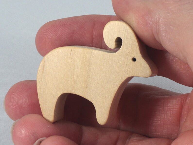 This is an unfinished wooden Ram cutout from solid wood using traditional woodworking techniques. Sanded smooth and ready to paint, stain, or customize. Freestanding design for small hands, toddlers, young children, crafters, collectors, and display. I take custom orders for any animal, quantity, and mix — including large ornament orders. Mix and match, request a different size, or send a drawing or pattern. Handmade by Odin's Toy Factory in Tallahassee, Florida, USA.