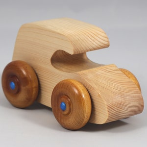 Handmade wooden toy car. The body is finished with clear shellac, and the wheels are finished with amber shellac. The hubs are painted with metallic sapphire blue trim.