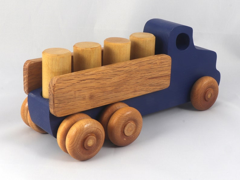 This handmade wooden Lorry truck is finished with navy blue acrylic paint and Amber Shellac. It is one of five towable trucks in this collection, available in many colors and unfinished. Custom Orders are welcome.